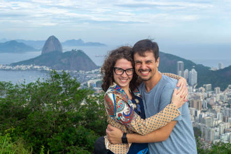 view of a loving couple embracing with the Guanabara bay in the background.の写真素材