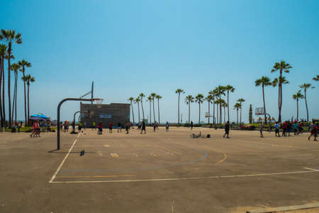 LOS ANGELES, USA - JUNE 25, 2016: People playing basketball on Venice Beach on summer courts.のeditorial素材