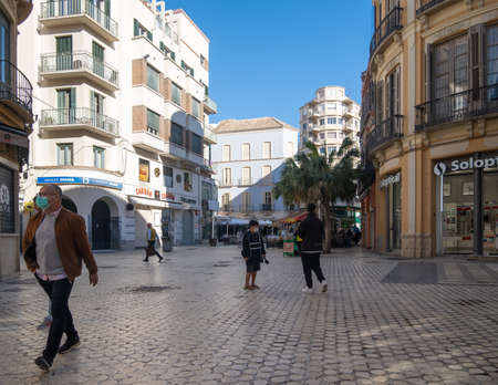 Malaga, Spain - February 23, 2021: View of people walking the streets of the historic center of Malaga during the pandemic.のeditorial素材