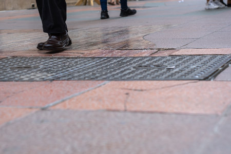 close-up view of people's feet walking in shopping street..の写真素材