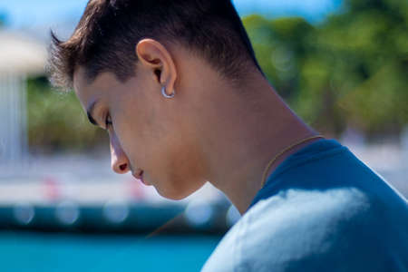 View of a teenager in the port of Malaga looking at the sea.の写真素材