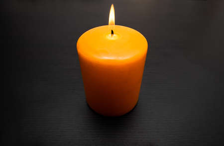 View of burning orange candle for Halloween party with copy space.の写真素材