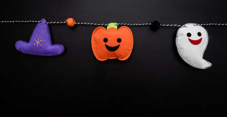 View of cotton Halloween elements on a garland with copy space.の写真素材
