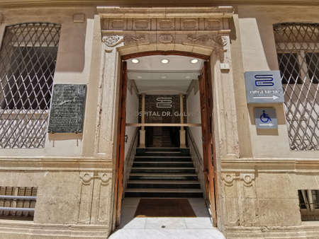 MÃ¡laga, Spain - JUNE 16, 2021: View of entrance and facade of Dr. GalvÃ©s Hospital.のeditorial素材