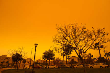 Malaga, Spain - March 24, 2022: Apocalyptic vision of the muddy sky in Malaga due to the arrival of the Saharan fog with no filter.の写真素材