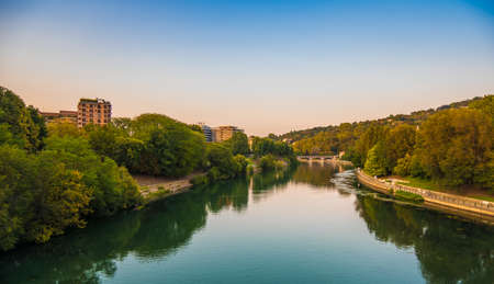 Beautiful sunset view of the arch bridge over the river Po in the city of Turin, Italy.の写真素材
