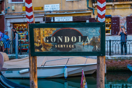 VENICE, ITALY - August 27, 2021: Board view with gondola service on the canals of Venice.の写真素材