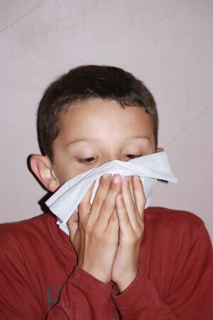 child blowing her noseの写真素材