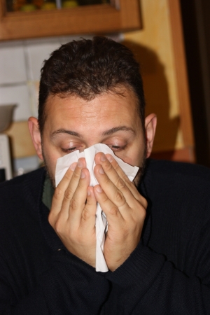 Man blowing his noseの写真素材