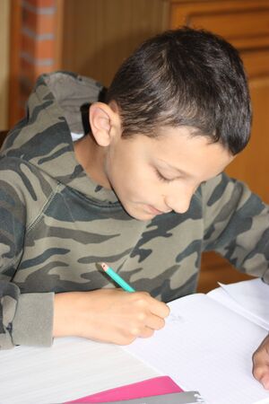 boy doing his homeworkの写真素材