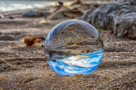 beach seen in a glass ballの写真素材