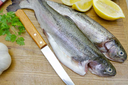 whole trout on a cutting boardの写真素材
