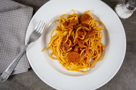 plate of spaghetti with arrabiata on a tableの写真素材