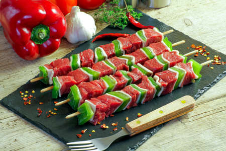Beef skewers on a wooden tableの写真素材