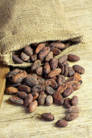 cocoa beans on a wooden tableの写真素材