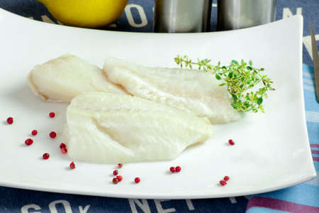 raw sea bass fillet in a plate