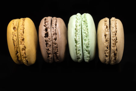 several macaroons isolated on a black background