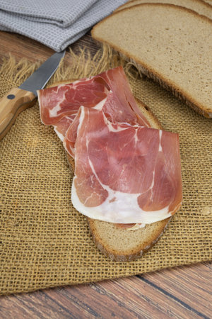 dry slice of ham on a wooden tableの写真素材