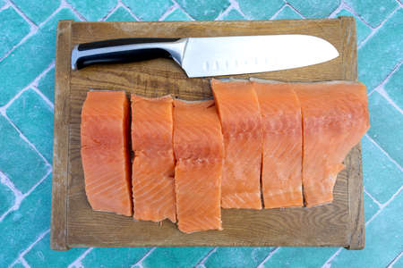 pieces of raw salmon on a cutting board