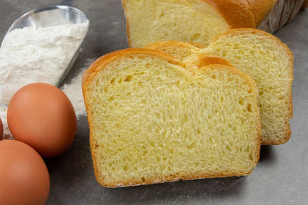 sliced brioche on a gray table