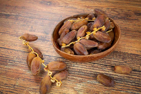 plate of dates isolated on a wooden table