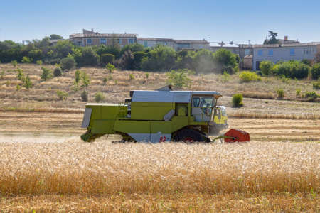 combine harvester working on a wheat fieldの写真素材