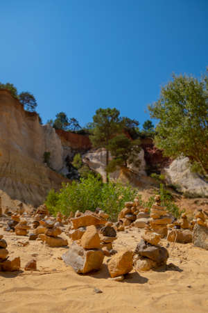 small piles of pebbles on the Colorado ProvenÃ§al site in Rustrel (France)の写真素材