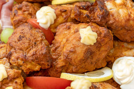 pieces of cooked chicken in a dishの写真素材