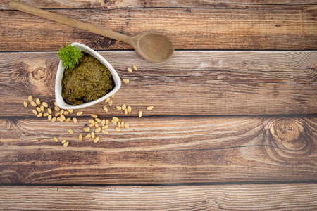 dish of pesto sauce on a wooden tableの写真素材