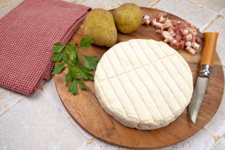ingredients for tartiflette on a cutting boardの写真素材