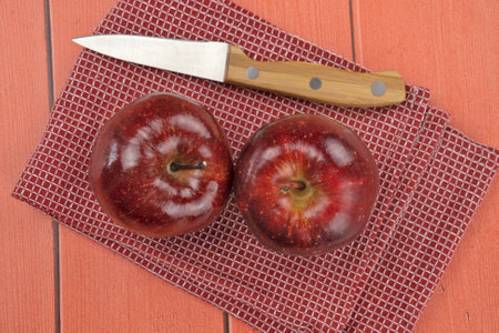 ripe apples on red wooden backgroundの写真素材