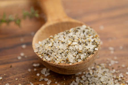 wooden spoon with mixed salt and dried spices on wooden backgroundの写真素材