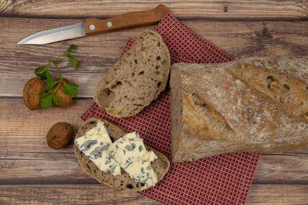 bread with nuts and french roquefort on a wooden board