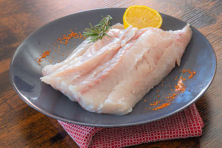 fillet of raw saith with spices and herbsの写真素材