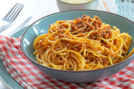 spaghetti bolognese in a blue plateの写真素材