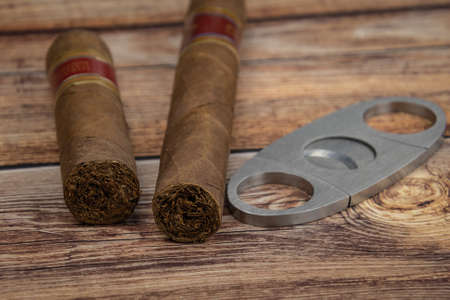 Straight cutter (or Guillotine) and cigars on wooden background.の写真素材