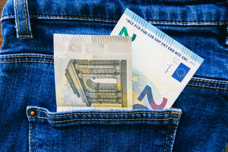 euro banknotes in the pocket of jeans close-upの写真素材