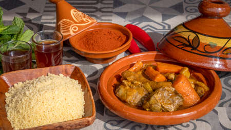 royal couscous with semolina spices and tea on a tableの写真素材