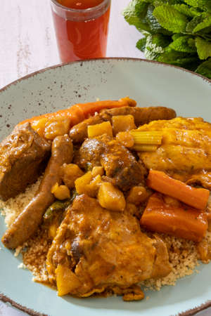 royal couscous in a plate on a table with a glass of teaの写真素材