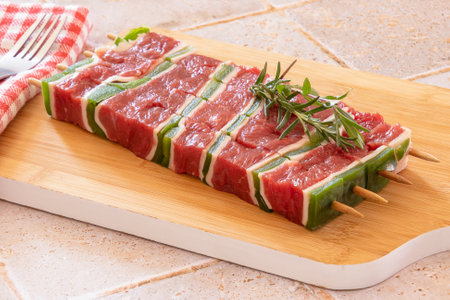 raw beef skewer on a wooden boardの写真素材