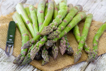 fresh green asparagus on wooden backgroundの写真素材