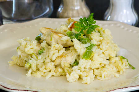 chicken and green asparagus risotto on a plateの写真素材