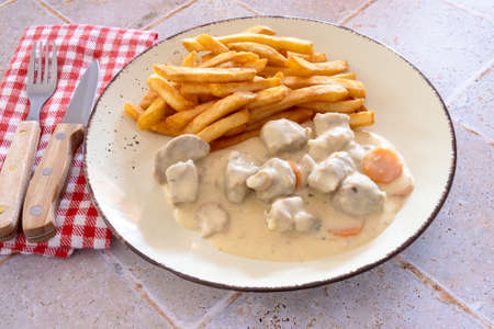 french fries and veal meat with mushrooms and carrotsの写真素材