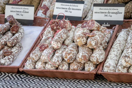 several dry sausages on a market stallの写真素材