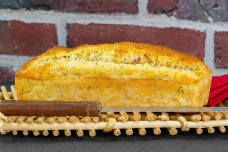 savory cake with whole ham on a basket on a tableの写真素材
