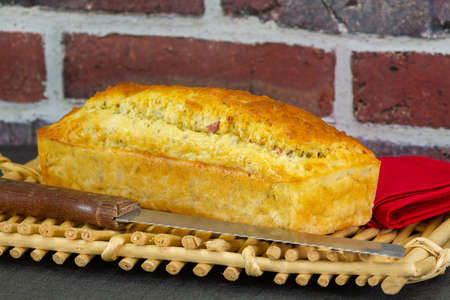 savory cake with whole ham on a basket on a tableの写真素材