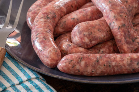close up of raw herb sausages on a plateの写真素材
