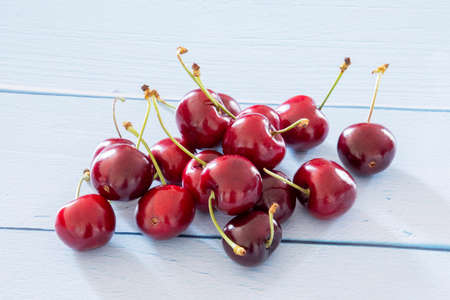 several red cherries on a light background