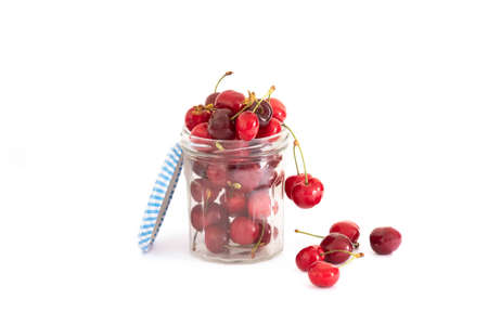 several ripe red cherries in a jarの写真素材