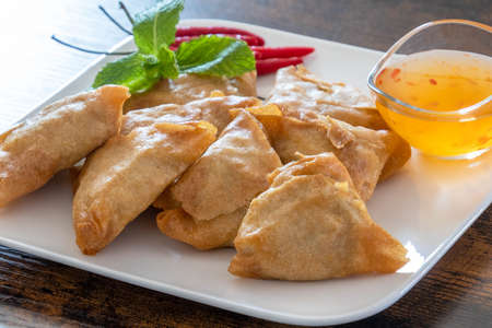 samosa on a plate with sweet and sour sauceの写真素材